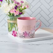 Show your mom how much you love and admire her every single day with the More Precious than Rubies Pink Floral Ceramic Coffee Mug. This beautiful mug is a heartfelt gift that will undoubtedly become her favorite choice for morning coffee or evening tea. Its beauty and sentiment will be a constant reminder of your deep love and appreciation for her.